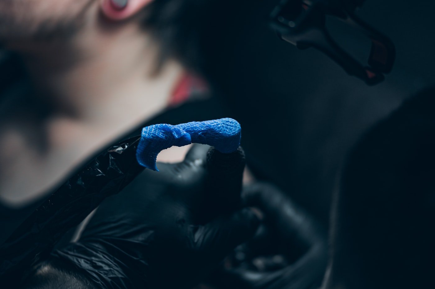 Tattoo artist tattooing a client, close-up session in a studio