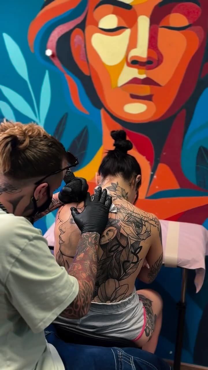 Paride, fine line and floral tattoo artist, working in his studio